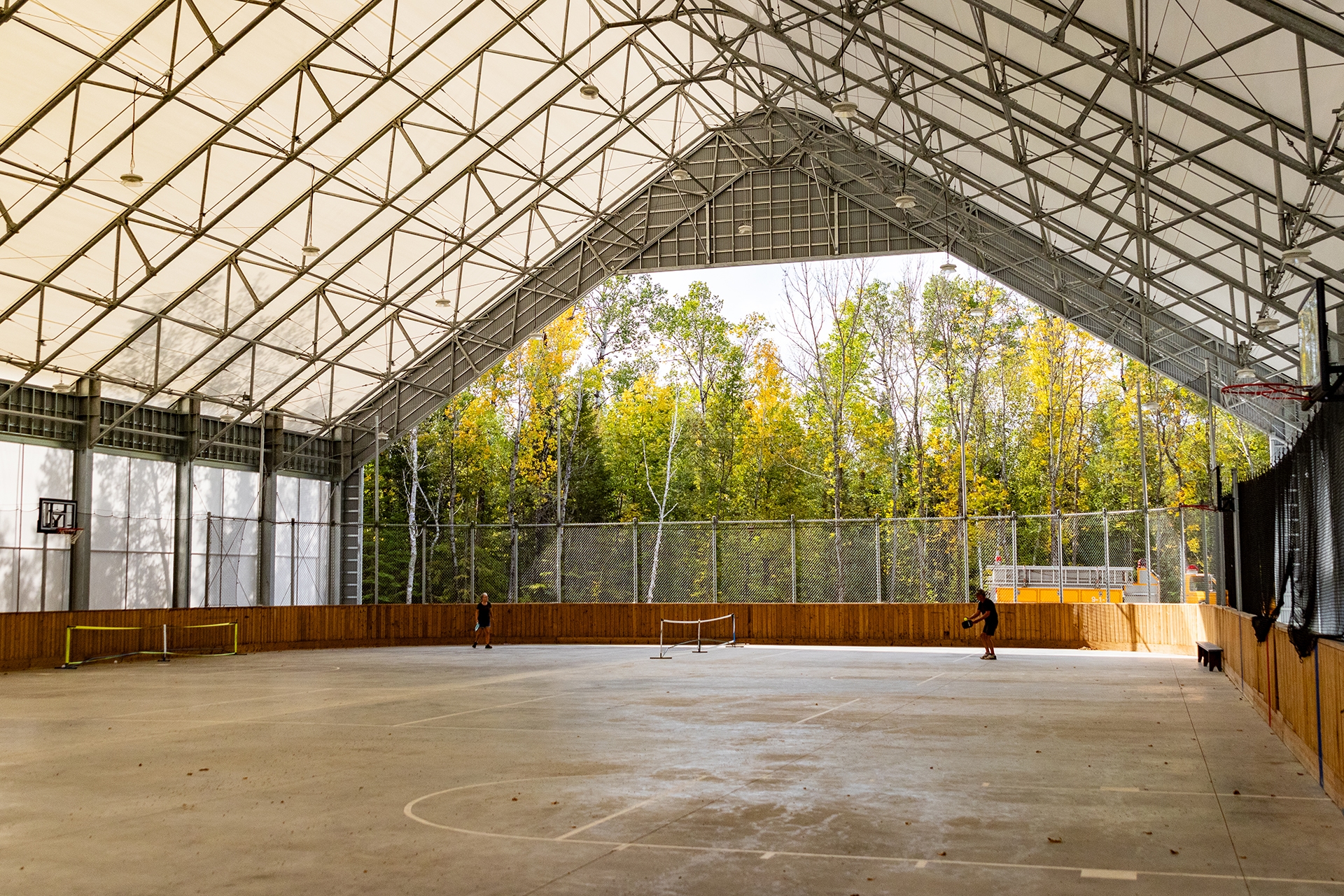 A large open air pavilion with a roof and a flat surface