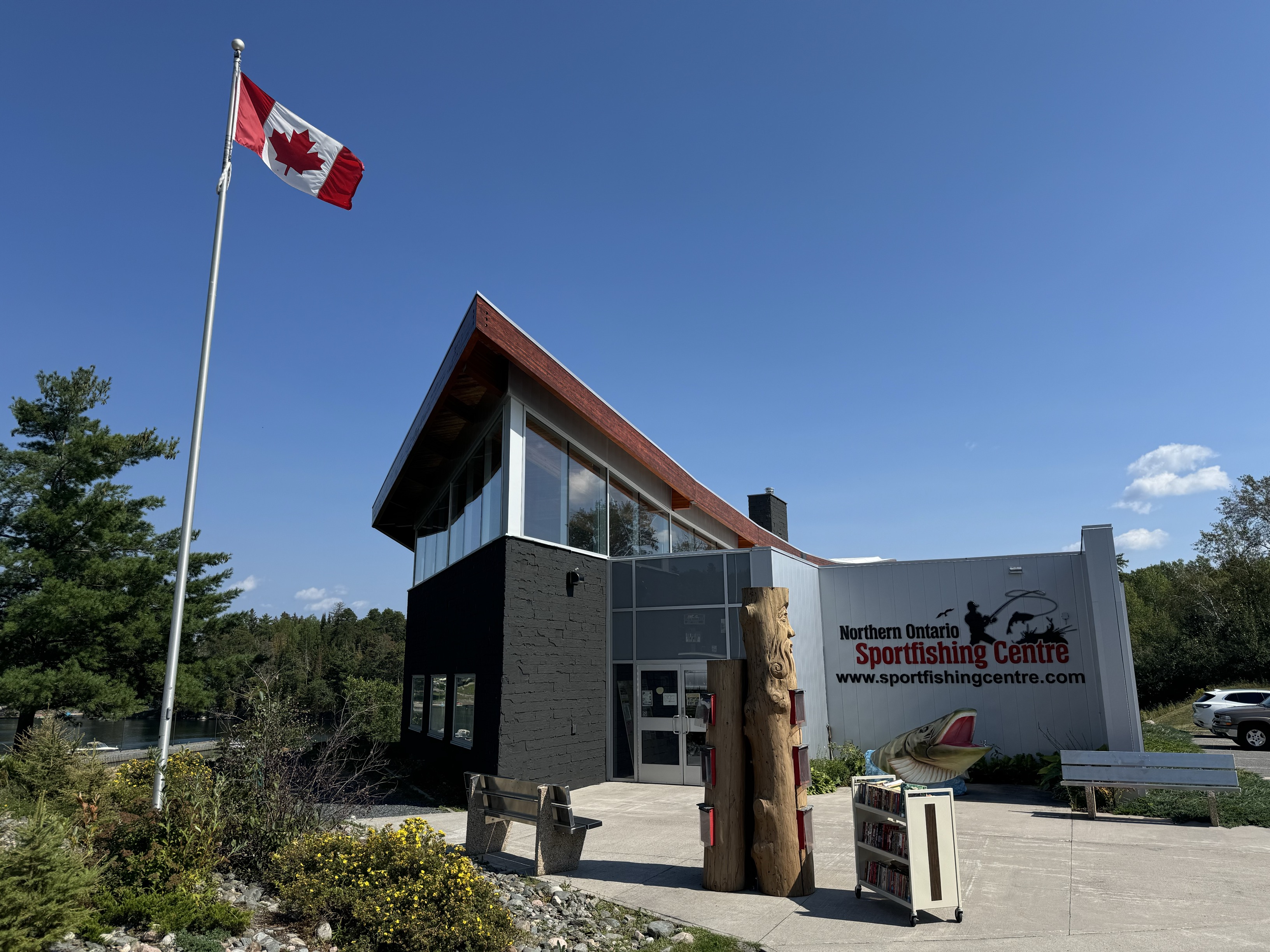 A modern looking building with tall windows and a sign that reads Northern Ontario Sportfishing Centre