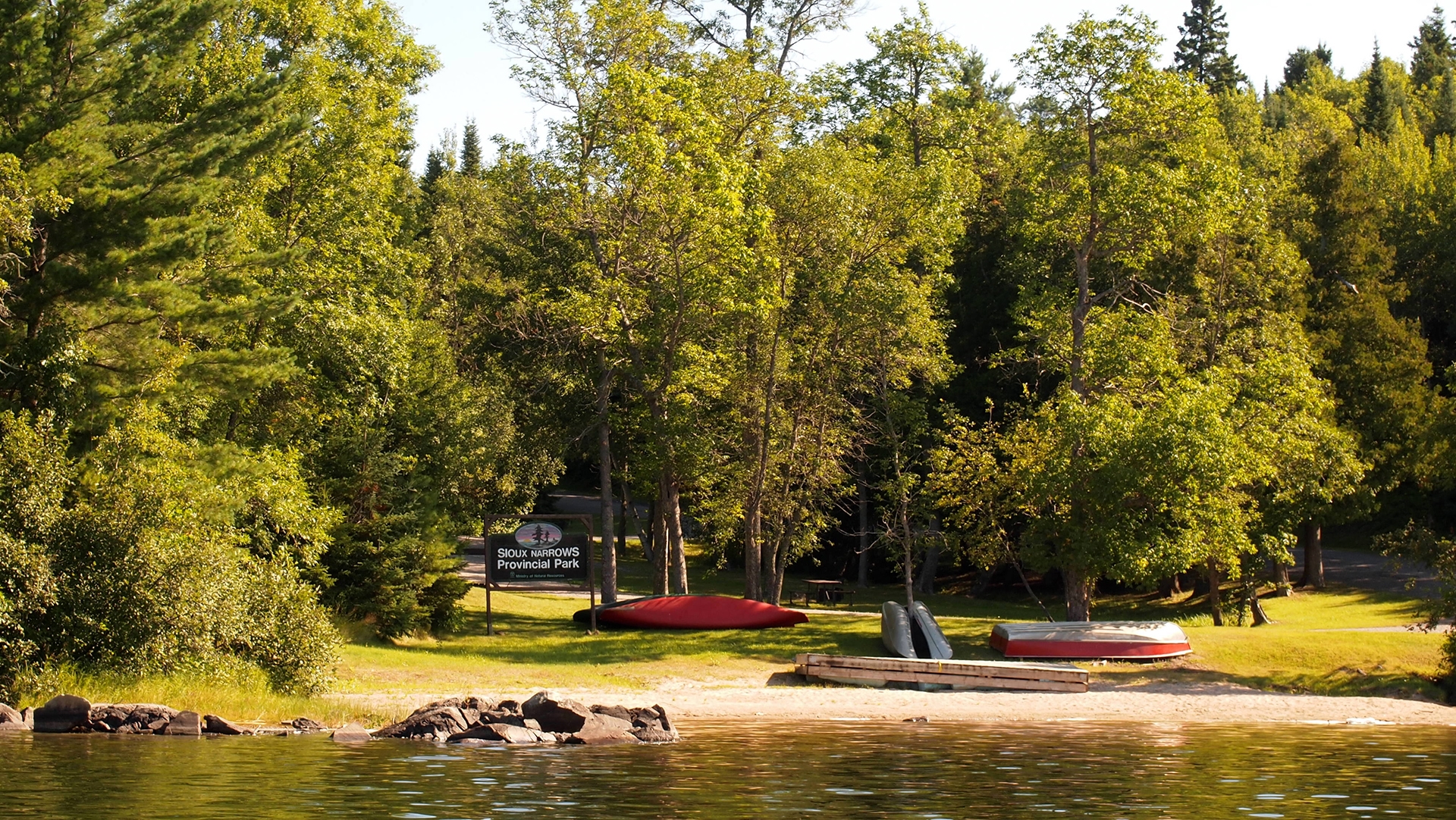 The waterfront area of a beach surrounded by trees